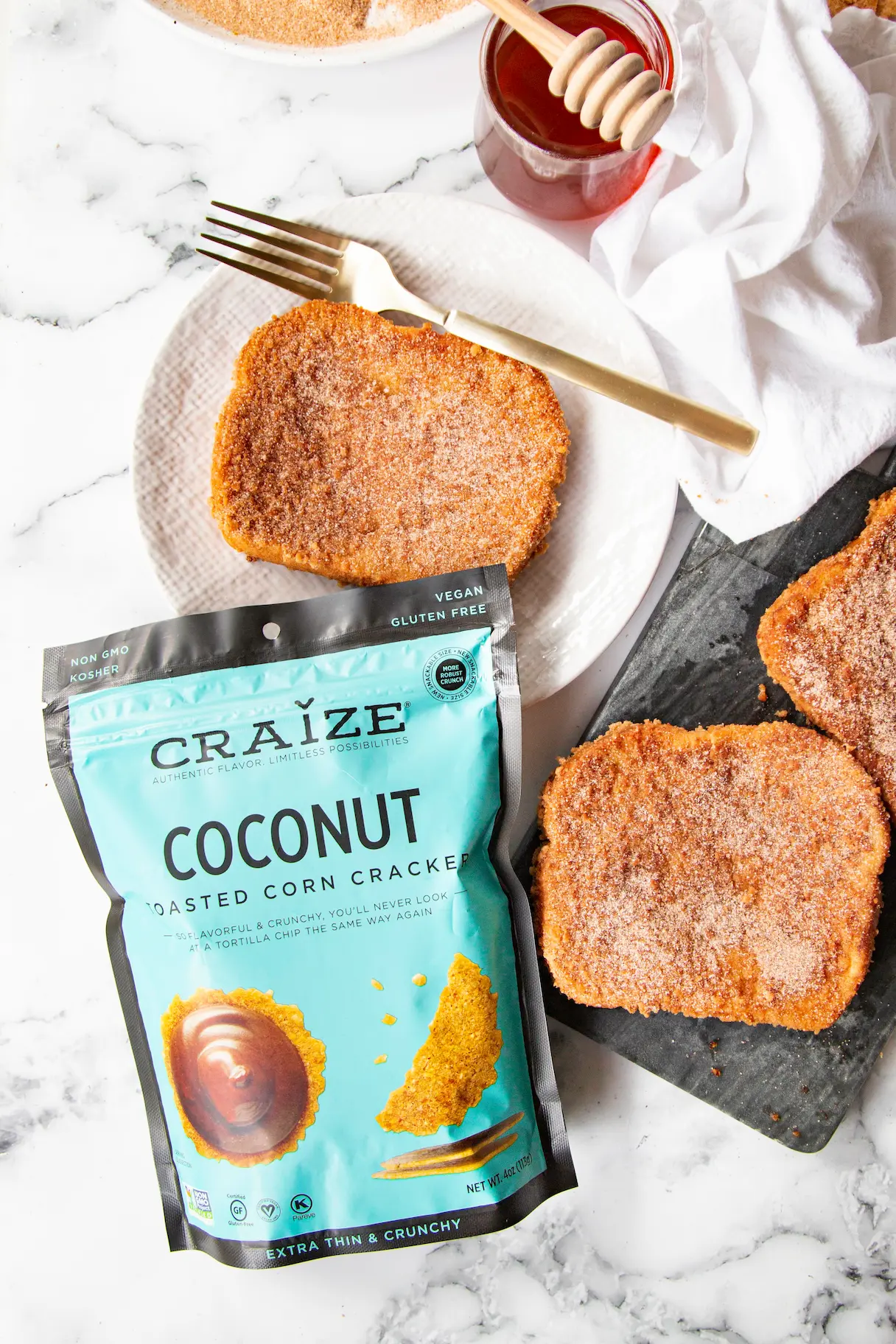 Craize Coconut bag beside cinnamon sugar toast on plates with honey dipper and fork.